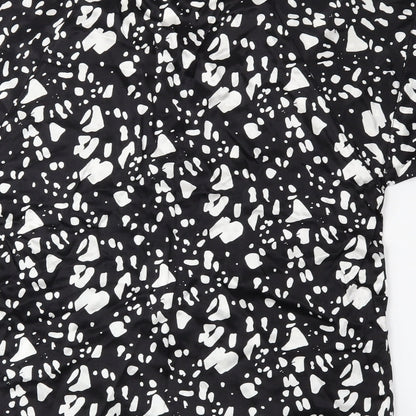 Brand and care label for River Island women’s black polka dot basic blouse, size UK 8