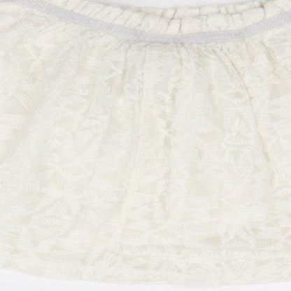 Brand and care label for F&F girls’ white geometric a-line skirt, size 3-4, years