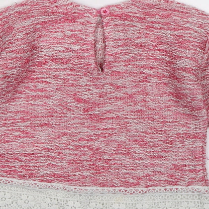 Brand and care label for Primark girls’ pink knit jumper, size 3-6, months