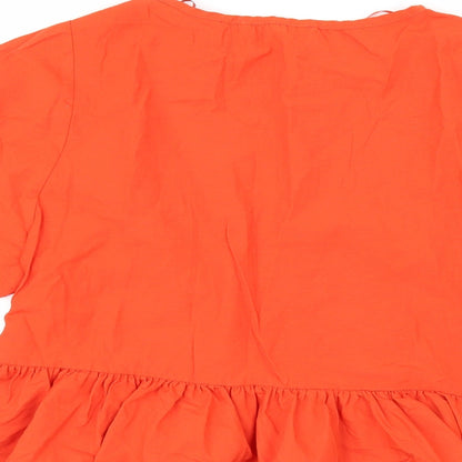 Brand and care label for Primark women’s orange tunic blouse, size UK 8