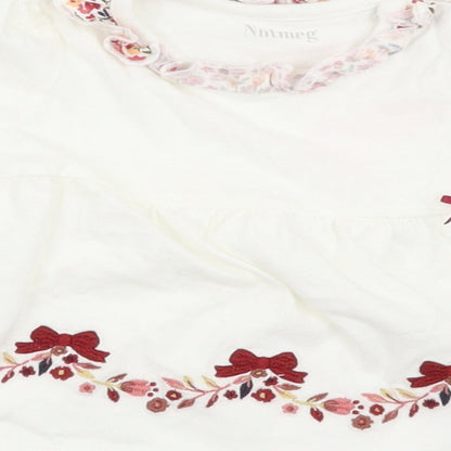 Brand and care label for Nutmeg girls’ white floral basic t-shirt, size 3-6, months