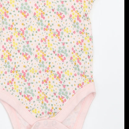 Brand and care label for F&F girls’ multicoloured floral babygrow one-piece, size 3-6, months