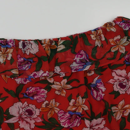 Close-up detail of preworn women’s red floral basic blouse, size UK 10