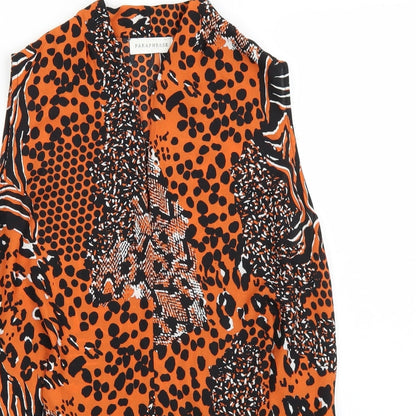 Close-up detail of Paraphrase women’s orange animal print basic blouse, size UK 10