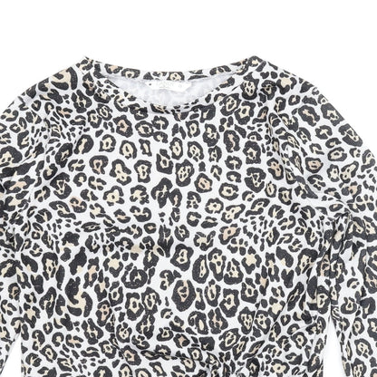 Close-up detail of Candy Couture girls’ beige animal print basic blouse, size 13, years