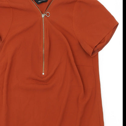 Close-up detail of New Look women’s orange basic blouse, size UK 8