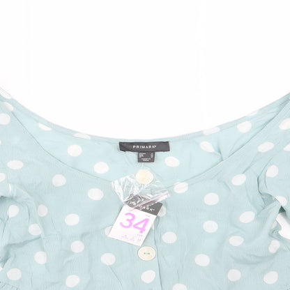 Close-up detail of Primark women’s green polka dot basic blouse, size UK 6