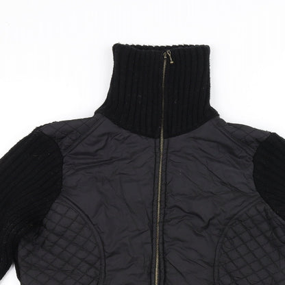 Close-up detail of text women’s black jacket, size M