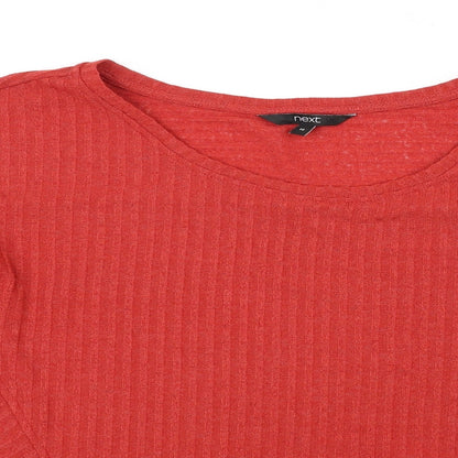 Close-up detail of Next women’s orange jumper, size UK 14