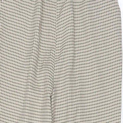 Close-up detail of Preworn women’s white trousers, size UK 18, 27-inch leg