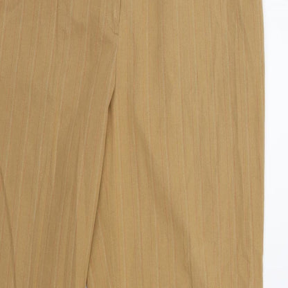 Close-up detail of Preworn women’s orange trousers, size UK 12, 30-inch leg