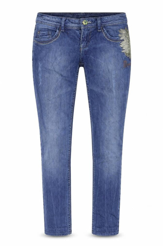 Front view of women’s blue denim skinny jeans, size UK 30, 28-inch leg - flower print