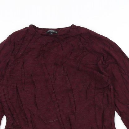 Close-up detail of Next women’s red jumper, size XS
