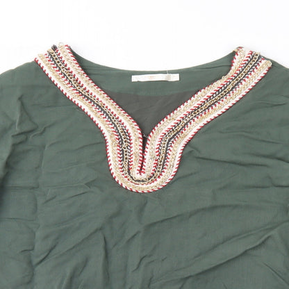 Close-up detail of Cherry women’s green geometric basic blouse, size UK 12