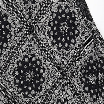 Brand and care label for Peacocks women’s black floral basic blouse, size M