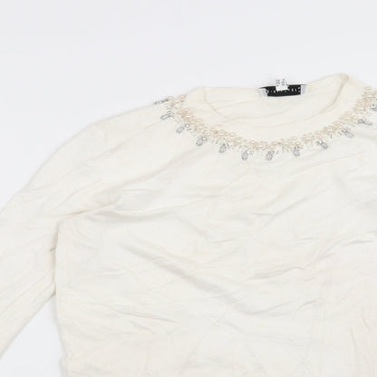Close-up detail of Warehouse women’s white jumper, size UK 10