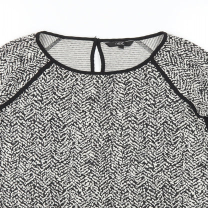 Close-up detail of Next women’s black polka dot jumper, size UK 8