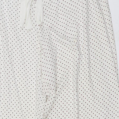 Close-up detail of Secret Obsessions women’s ivory polka dot trousers, size L, 22-inch leg