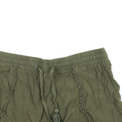 Close-up detail of Primark women’s green paperbag shorts, size UK 8