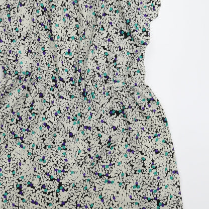 Brand and care label for F&F women’s white floral jumpsuit one-piece, size UK 8