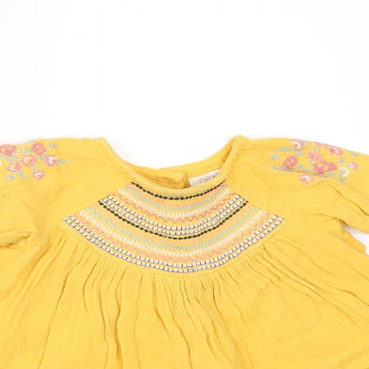 Close-up detail of Next girls’ yellow a-line, size 3-6, months