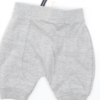 Brand and care label for Baby boys’ grey capri trousers, size 0-3, months