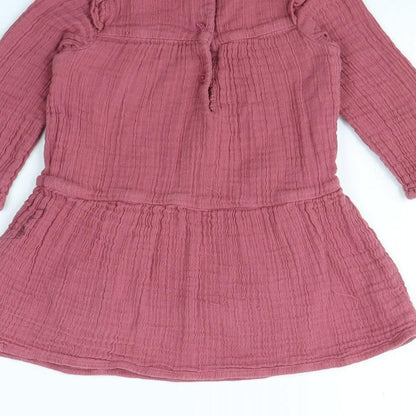 Brand and care label for Tu girls’ pink fit & flare, size 18, months