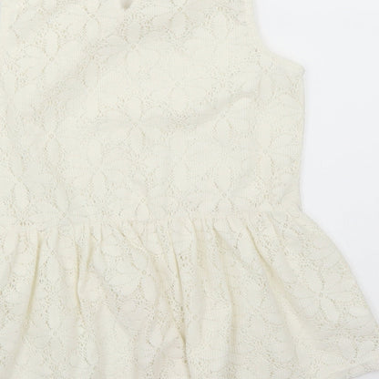 Brand and care label for George girls’ ivory basic blouse, size 8-9, years