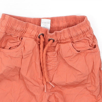 Close-up detail of Tu boys’ orange cargo trousers, size 18-24, months
