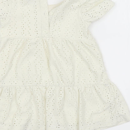 Brand and care label for Primark girls’ yellow shift, size 9-12, months