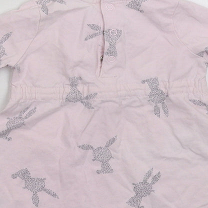 Brand and care label for F&F girls’ pink jumper dress, size 3-6, months