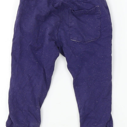 Brand and care label for Team Spirit boys’ blue sweatpants, size 9-12, months