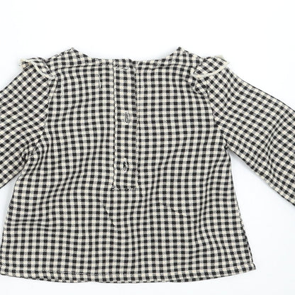 Brand and care label for Primark girls’ black check basic blouse, size 3-6, months
