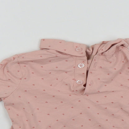 Close-up detail of Primark girls’ pink basic t-shirt, size 9-12, months