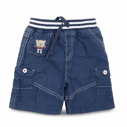 Front view of Tu boys’ blue cropped trousers, size 9-12, months