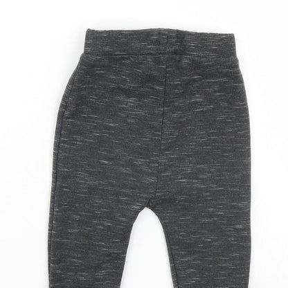 Brand and care label for Disney boys’ black sweatpants, size 6-9, months