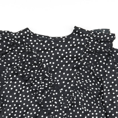 Close-up detail of I SAW IT FIRST women’s black polka dot basic blouse, size UK 14