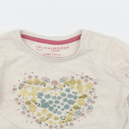 Close-up detail of Primark girls’ beige basic t-shirt, size 6-9, months