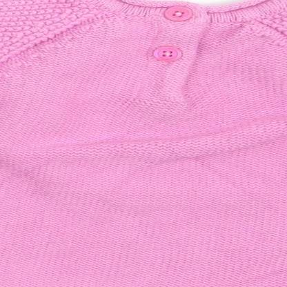Brand and care label for Nutmeg girls’ pink jumper, size 3-6, months