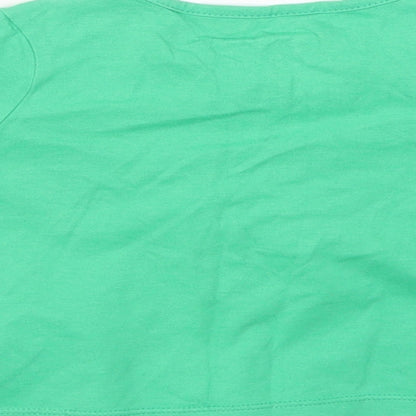 Brand and care label for George girls’ green jumper, size 9-12, months