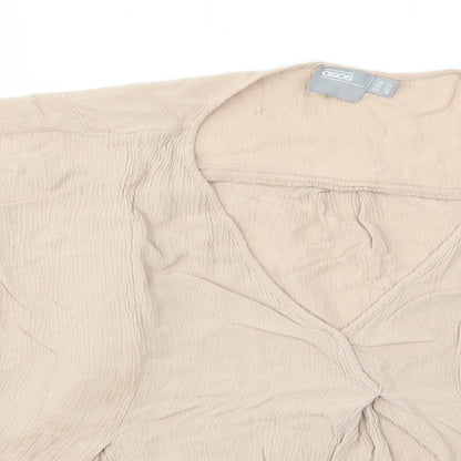 Close-up detail of ASOS women’s beige basic blouse, size UK 14