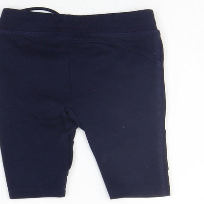Brand and care label for Gap girls’ blue jogger trousers, size 6-9, months