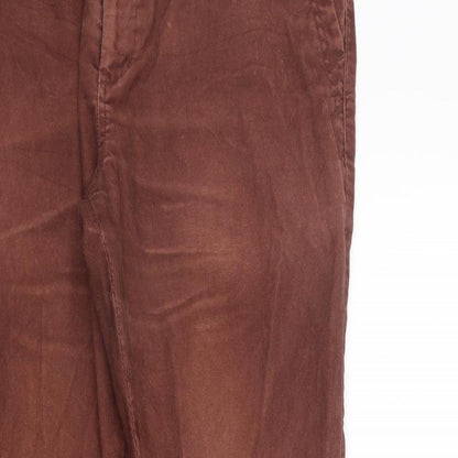 Close-up detail of Roman women’s orange trousers, size UK 36, in, 31-inch leg