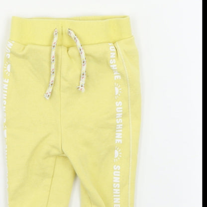Close-up detail of Primark boys’ yellow sweatpants, size 6-9, months