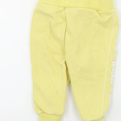 Brand and care label for Primark boys’ yellow sweatpants, size 6-9, months