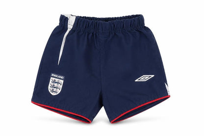 Front view of Umbro boys’ blue cropped trousers, size 6-9, months - england football shorts