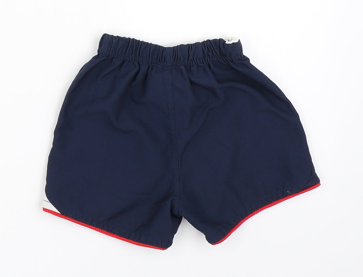Back view of Umbro boys’ blue cropped trousers, size 6-9, months - england football shorts