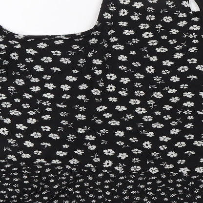 Brand and care label for New Look girls’ black floral basic blouse, size 14, years