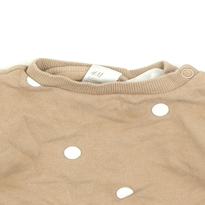 Close-up detail of H&M girls’ brown polka dot pullover t-shirt, size 0-3, months
