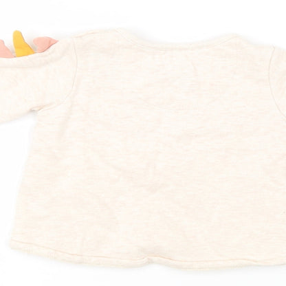 Brand and care label for F&F girls’ pink jumper, size 3-6, months